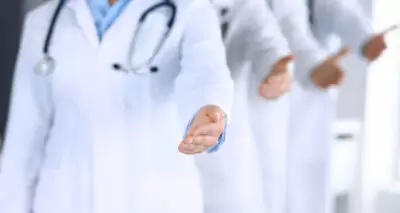 Group of doctors with their hands extended