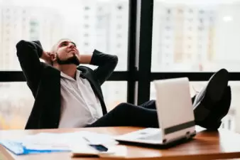 businessman leaning back at his desk