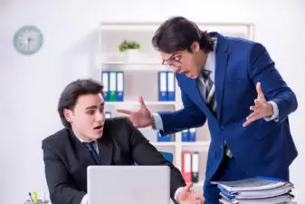 Boss and his male assistant working in the office