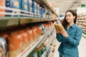 woman looking at food at the store