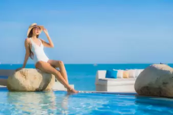 Young woman relaxing by pool