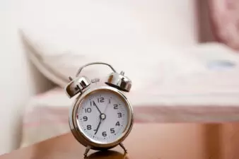 Alarm clock on night table at bed