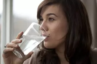 Young woman drinking a glass of water