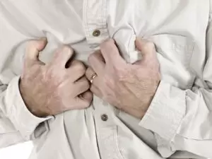 Old man having a chest pain isolated over the white background