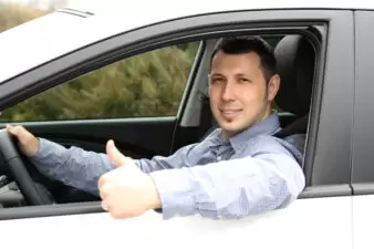 Portrait of young man sitting in the car