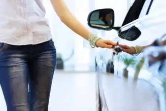 Woman running hand along car