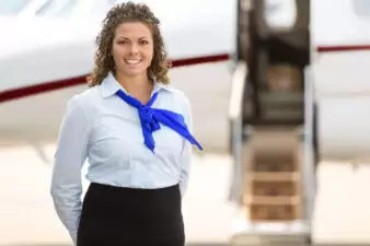 Stewardess posing in front of plane