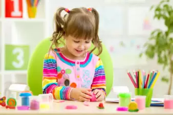 happy little girl doing crafts