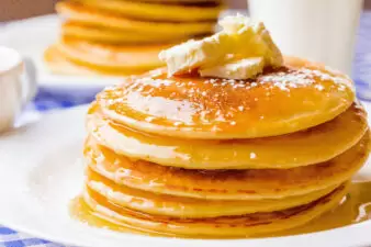 Stack of pancakes with syrup and butter