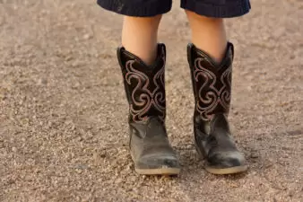 Cowboy boots standing in gravel