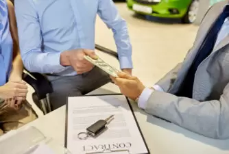 Customer handing over money for car