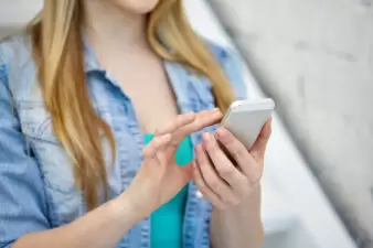 close up of female hands with smartphone