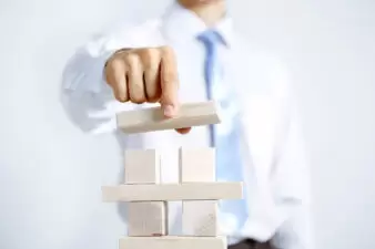 Businessman building a block tower