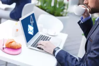 man looking at his email on his laptop