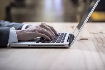 Close up of hands on a laptop