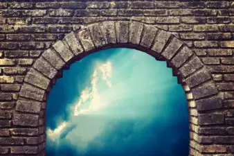 brick arch with sky in background