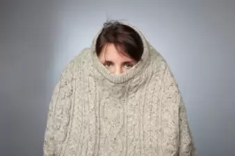 Introverted woman hiding in an oversized sweater