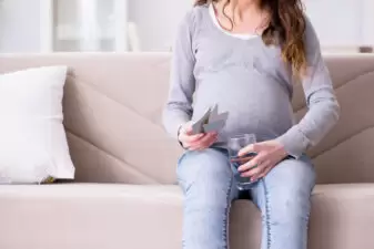 Pregnant woman sitting on sofa