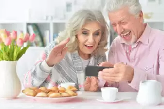 Elderly couple looking surprised at a phone