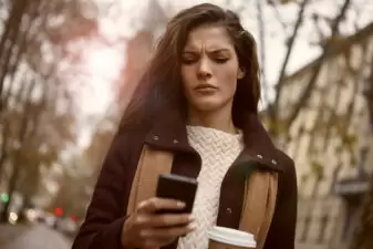 Concerned woman looking at her phone