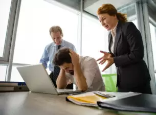 Angry boss screaming at workers