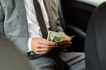 man counting dollar bills