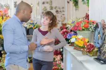 Person speaking with another person at flower shop