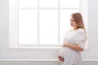 Pregnant woman in a white dress