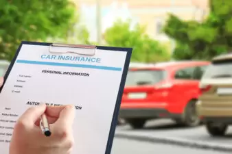 Person filling in information for car insurance