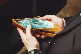 man holding open his wallet