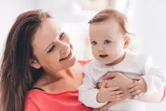 Happy mother holding her baby daughter