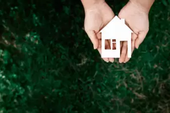 person holding a house