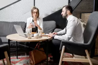 business man and woman speaking over a lunch meeting