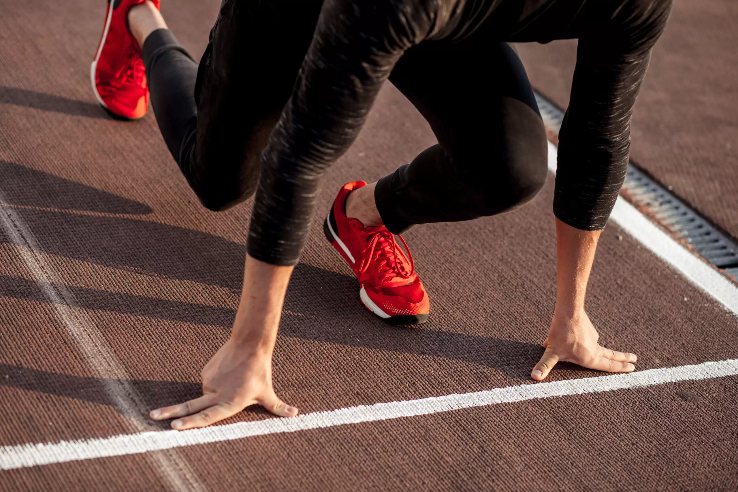 female runner on starting line of track