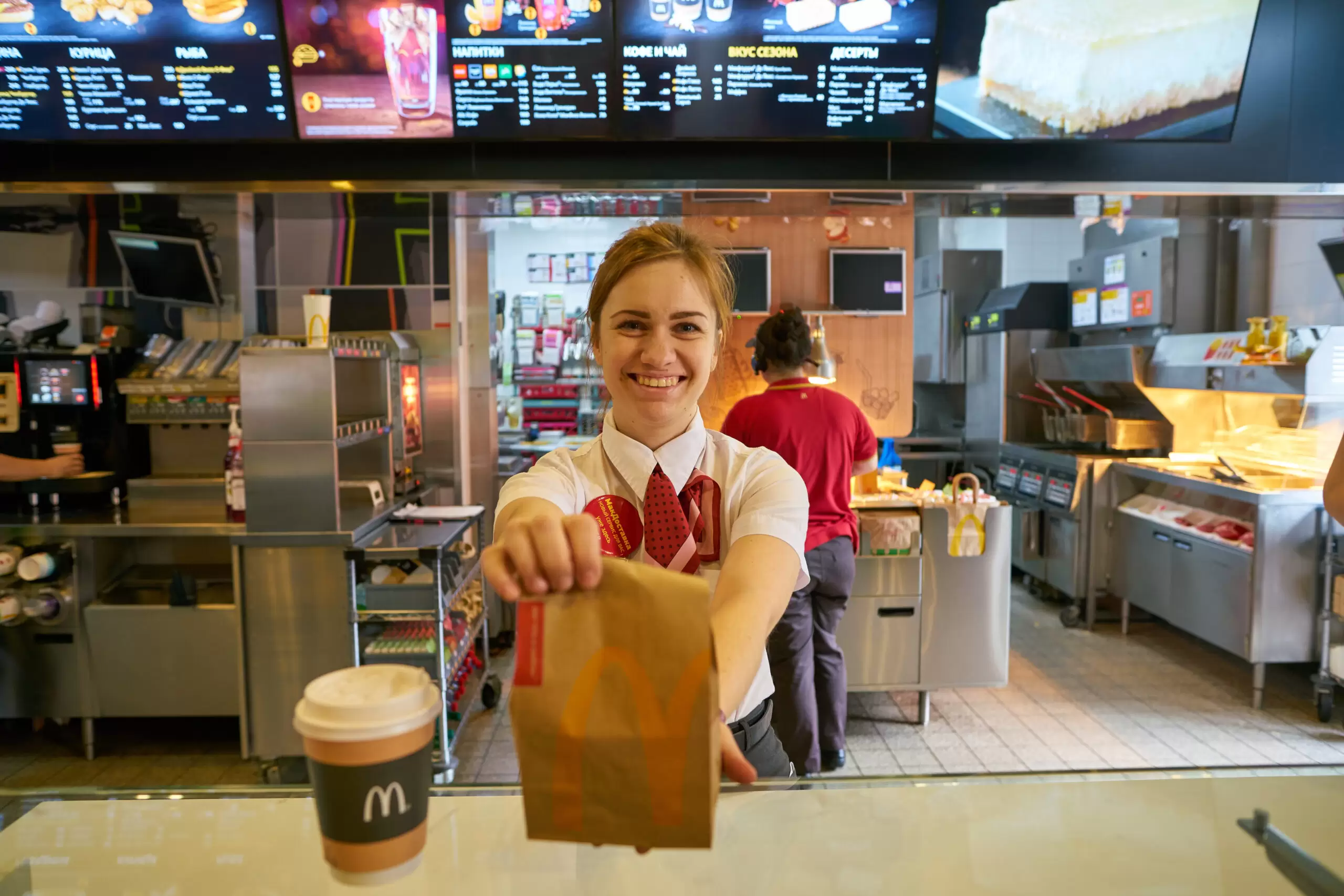 McDonald's working handing over bag